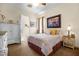 Cozy bedroom with warm lighting, a comfortable queen bed, and a quaint dresser with decor at 4208 Agosta Luna Pl, Las Vegas, NV 89135
