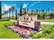 Welcoming entrance to Siena Golf Club & Bistro with colorful flower beds and lush landscaping at 4208 Agosta Luna Pl, Las Vegas, NV 89135