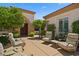 Inviting outdoor courtyard with seating, mature trees, and landscaped garden at 4208 Agosta Luna Pl, Las Vegas, NV 89135
