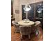 Cozy dining area with a round table, upholstered chairs, and sliding glass doors to the patio at 4208 Agosta Luna Pl, Las Vegas, NV 89135
