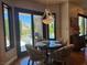 Dining area with a view of the pool, featuring a modern chandelier and hardwood floors at 4208 Agosta Luna Pl, Las Vegas, NV 89135