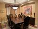 Elegant dining room with large table, decorative lighting, and sophisticated decor at 4208 Agosta Luna Pl, Las Vegas, NV 89135