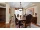 Elegant dining room featuring a chandelier, hardwood floors, and a large dining table at 4208 Agosta Luna Pl, Las Vegas, NV 89135