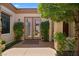 Charming home entrance with manicured bushes and stone-accented exterior at 4208 Agosta Luna Pl, Las Vegas, NV 89135