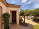 Inviting front entrance with a manicured landscape and shaded seating area at 4208 Agosta Luna Pl, Las Vegas, NV 89135