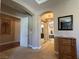 Inviting home entryway featuring neutral tones, arched doorways, and elegant decor, leading to the primary bathroom at 4208 Agosta Luna Pl, Las Vegas, NV 89135