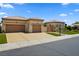 Charming single-story home featuring a three-car garage, well-manicured lawn, and inviting curb appeal at 4208 Agosta Luna Pl, Las Vegas, NV 89135