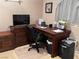 Cozy home office with dark wood desk and a comfortable chair, creating an ideal workspace at 4208 Agosta Luna Pl, Las Vegas, NV 89135