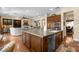 Open-concept kitchen island with stainless steel appliances seamlessly connecting to the living spaces at 4208 Agosta Luna Pl, Las Vegas, NV 89135