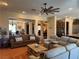 Open concept living room featuring modern furniture, a ceiling fan, and seamless flow to other rooms at 4208 Agosta Luna Pl, Las Vegas, NV 89135