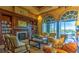 Cozy living room with custom built-ins, fireplace and oversized windows with scenic views of the lake at 4208 Agosta Luna Pl, Las Vegas, NV 89135
