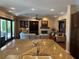 Spacious living room with a fireplace, built-in shelves, and open access to the kitchen at 4208 Agosta Luna Pl, Las Vegas, NV 89135