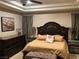 Bedroom featuring tray ceiling, decorative lamps, and coordinated furniture for a luxurious feel at 4208 Agosta Luna Pl, Las Vegas, NV 89135