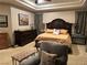 Cozy bedroom with a large bed, dresser, side tables, and comfortable seating at 4208 Agosta Luna Pl, Las Vegas, NV 89135