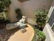 Private outdoor patio with lounge chair, side table, and beautiful landscaping at 4208 Agosta Luna Pl, Las Vegas, NV 89135