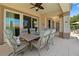 Covered patio area with a ceiling fan and comfortable seating, perfect for al fresco dining and outdoor living at 4208 Agosta Luna Pl, Las Vegas, NV 89135
