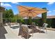 Outdoor patio with an umbrella for shade and comfortable seating, perfect for outdoor entertaining and relaxation at 4208 Agosta Luna Pl, Las Vegas, NV 89135