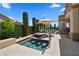 Inviting backyard pool with an umbrella-covered seating area and built-in bar stools for outdoor relaxation at 4208 Agosta Luna Pl, Las Vegas, NV 89135