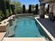 The stunning backyard pool features a tanning shelf and seating, perfect for relaxing and enjoying the outdoors at 4208 Agosta Luna Pl, Las Vegas, NV 89135
