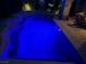 Inviting swimming pool illuminated with brilliant blue lights for nighttime enjoyment at 4208 Agosta Luna Pl, Las Vegas, NV 89135