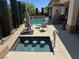 An alluring pool area with a swim-up bar, loungers and a grill, creating an idyllic outdoor oasis at 4208 Agosta Luna Pl, Las Vegas, NV 89135