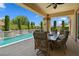 Relaxing outdoor dining area on the pool patio with a covered seating area at 4208 Agosta Luna Pl, Las Vegas, NV 89135