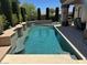 Serene pool area surrounded by lush greenery, providing a peaceful retreat for relaxation and recreation at 4208 Agosta Luna Pl, Las Vegas, NV 89135