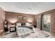 Spacious bedroom features a large bed, modern décor, and access to the backyard at 4213 Essex Green Ct, Las Vegas, NV 89110