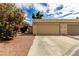 Home featuring a two-car garage with desert landscaping at 4213 Essex Green Ct, Las Vegas, NV 89110
