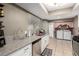Bright kitchen features granite countertops, stainless steel appliances, and tile flooring at 4213 Essex Green Ct, Las Vegas, NV 89110