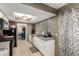 Well-lit kitchen equipped with white cabinetry, stainless steel appliances, and tile flooring at 4213 Essex Green Ct, Las Vegas, NV 89110