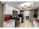 Kitchen with white cabinets, tile floors, modern appliances and granite countertops at 4213 Essex Green Ct, Las Vegas, NV 89110