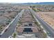 Aerial view of a neighborhood featuring houses with tile roofs, solar panels, and desert landscaping at 4589 Swimming Minnow Ave, Las Vegas, NV 89141