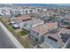 Aerial view of a well-maintained community with houses, solar panels, backyards, and city views at 4589 Swimming Minnow Ave, Las Vegas, NV 89141