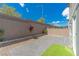 The backyard features a brick patio, gravel landscaping, and block wall fencing for privacy at 4589 Swimming Minnow Ave, Las Vegas, NV 89141