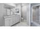 Bathroom featuring a double vanity with quartz countertops and bright modern fixtures and a large mirror at 4589 Swimming Minnow Ave, Las Vegas, NV 89141