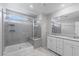 Contemporary bathroom featuring a glass-enclosed shower, dual sinks, and a large mirror at 4589 Swimming Minnow Ave, Las Vegas, NV 89141