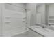 Bathroom featuring a shower-tub combo, white cabinets, and gray quartz countertop at 4589 Swimming Minnow Ave, Las Vegas, NV 89141