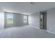 The empty bedroom has neutral carpet, two bright windows, and ample space to make it your own at 4589 Swimming Minnow Ave, Las Vegas, NV 89141