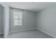 An empty bedroom with plush carpeting and a bright window offers a cozy atmosphere at 4589 Swimming Minnow Ave, Las Vegas, NV 89141