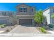 Charming two-story home with a paver driveway, desert landscaping and two-car garage at 4589 Swimming Minnow Ave, Las Vegas, NV 89141