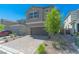 Charming two-story home with a paver driveway, desert landscaping and two-car garage at 4589 Swimming Minnow Ave, Las Vegas, NV 89141