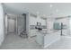 Contemporary kitchen features white cabinets, a center island, stainless steel appliances and a tile backsplash at 4589 Swimming Minnow Ave, Las Vegas, NV 89141