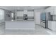 Stylish kitchen boasting white cabinetry, an island with a sink, and stainless appliances at 4589 Swimming Minnow Ave, Las Vegas, NV 89141