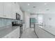 A modern kitchen with white cabinets, stainless steel appliances, and a stylish backsplash at 4589 Swimming Minnow Ave, Las Vegas, NV 89141