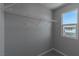 A bright walk-in closet with an installed shelf and a window for natural light at 4589 Swimming Minnow Ave, Las Vegas, NV 89141