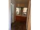 Bathroom featuring double sinks, wooden cabinets, and bright lighting at 5020 Wildroot Rd, Las Vegas, NV 89130