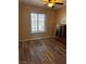 Bedroom featuring a ceiling fan, wood-look flooring, and a window for natural light at 5020 Wildroot Rd, Las Vegas, NV 89130