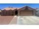 Charming single-story home featuring a desert landscape, barrel tile roof, and two-car garage at 5020 Wildroot Rd, Las Vegas, NV 89130