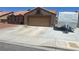 Charming single-story home featuring a desert landscape, barrel tile roof, and two-car garage at 5020 Wildroot Rd, Las Vegas, NV 89130
